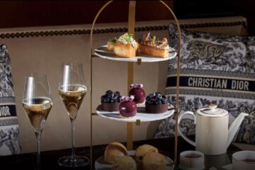 Afternoon tea at the Four Seasons Hotel Prague with cakes, pastries, and hot chocolate served in the elegant flower-filled lobby in winter.