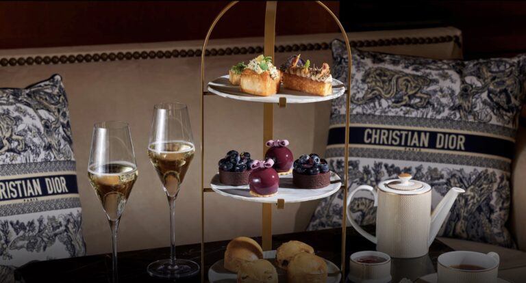 Afternoon tea at the Four Seasons Hotel Prague with cakes, pastries, and hot chocolate served in the elegant flower-filled lobby in winter.