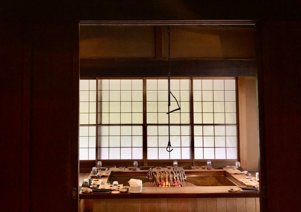 Traditional irori hearth inside Yanagiya in Gifu, Japan—an intimate countryside restaurant where seasonal river fish and wild game are grilled over charcoal in a historic farmhouse setting.