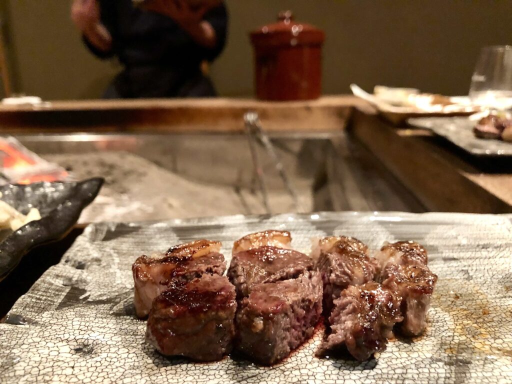 Grilled wild venison served at the famous Yanagiya Restaurant in Gifu, Japan — tender cuts seared over an irori hearth, showcasing the restaurant’s mastery of traditional mountain cuisine using seasonal game and natural charcoal fire.