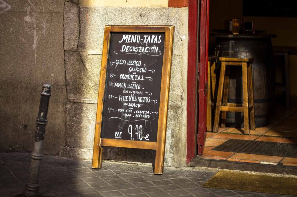 Traditional tapas bar in Madrid serve wine, jamón, and small plates of fresh food in a lively atmosphere.