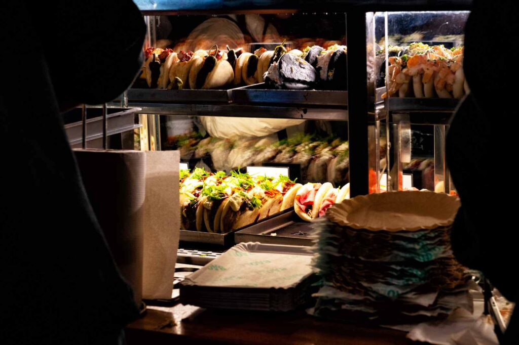 A tapas counter in Madrid displaying croquetas, tortilla, jamón, and other Spanish favorite foods.