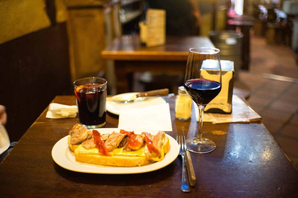 A typical tapas experience at a bar in Madrid includes Tinto de Verano or a glass of wine.