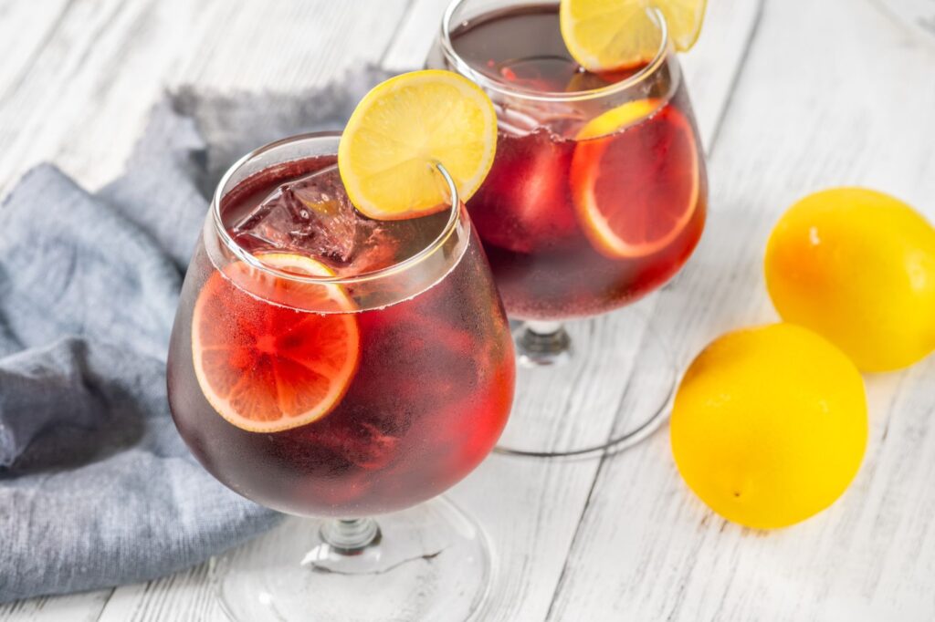Glass of Tinto de Verano with lemon slices, a refreshing Spanish summer drink enjoyed in Madrid tapas bars.