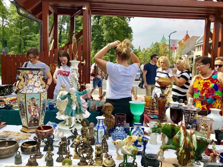 Hunting for antiques in Hungary, at the Hévíz Saturday flea market — tables filled with vintage porcelain, glassware, and collectibles.