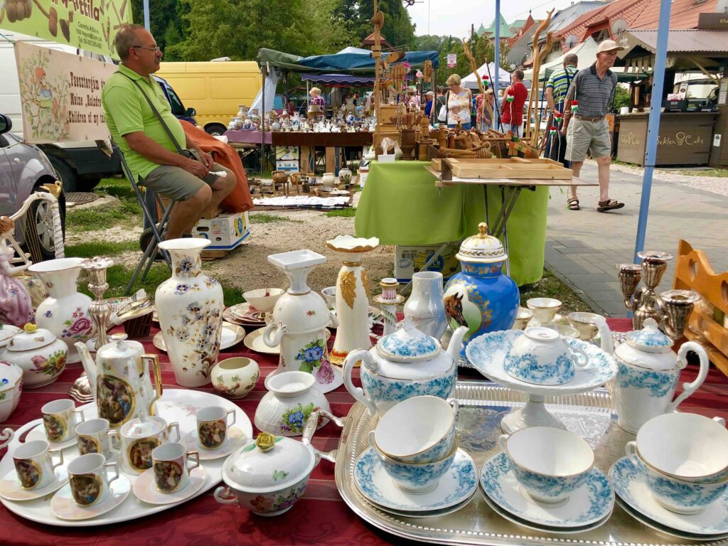 Close-up of Hungarian porcelain and vintage jewelry displayed at a flea market in Hévíz, a spa town that is also one of the best places to buy antiques in Hungary.