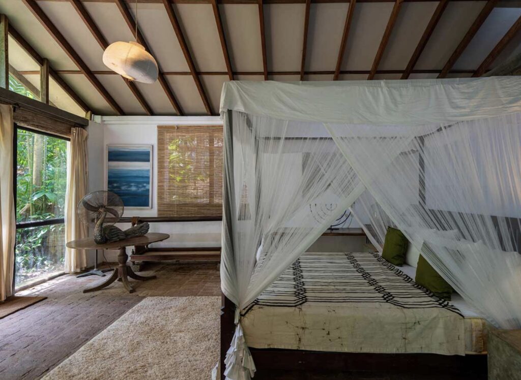 Bedroom at Lunuganga, Geoffrey Bawa's home in Sri Lanka. It opens directly onto a green courtyard, highlighting Bawa’s seamless connection between architecture and landscape.