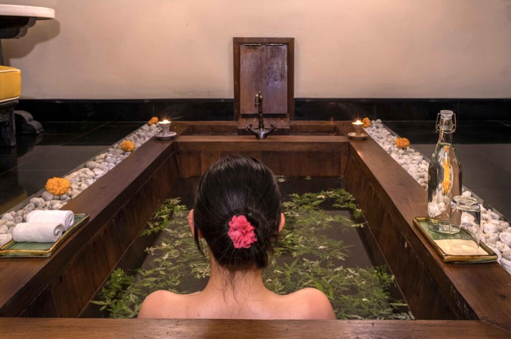 Experience the Bhutanese hot stone bath at the Lotus Spa of Pemako Punakha, a 5-star resort nestled in Bhutan's Punakha Valley.