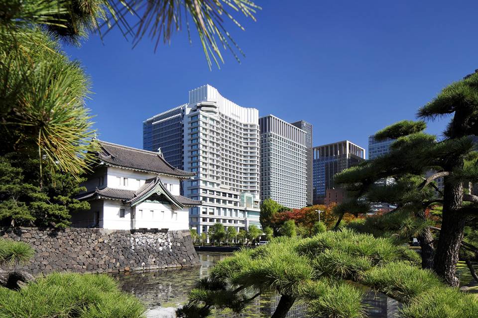 View of the Imperial Palace East Gardens from Palace Hotel Tokyo, showing stone walls, calm ponds, and seasonal greenery in a serene historic landscape.