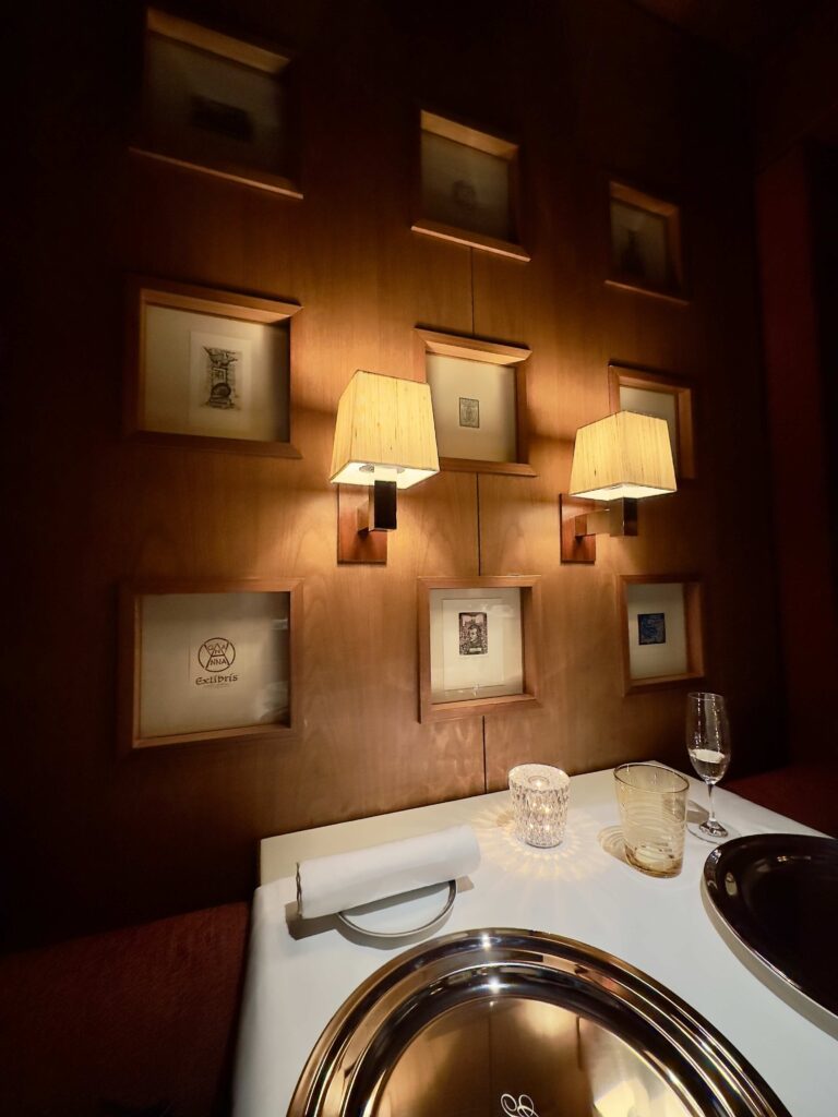 Banquet seating at Girandole at the new Park Hyatt Tokyo, featuring framed miniature artworks and warm sconces that evoke the hotel’s signature blend of contemporary design and timeless Japanese elegance.