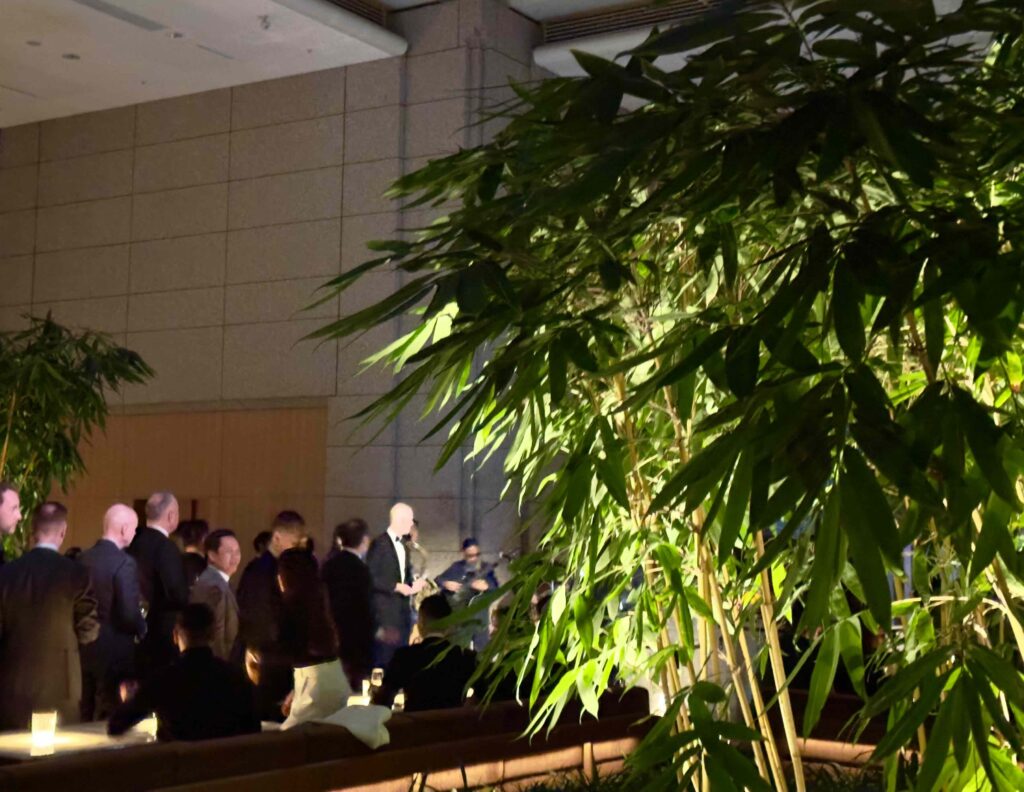 Guests mingle beside the softly illuminated bamboo garden during the reopening celebration of Park Hyatt Tokyo — a serene, green centerpiece that welcomes visitors back to the hotel’s signature calm high above Shinjuku.