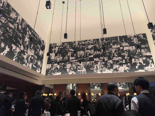 Guests gather beneath the iconic black-and-white mural photographs inside Girandole, Park Hyatt Tokyo’s all-day dining restaurant, during the hotel’s reopening celebration — a timeless space blending cinematic history, French flair, and Tokyo sophistication.