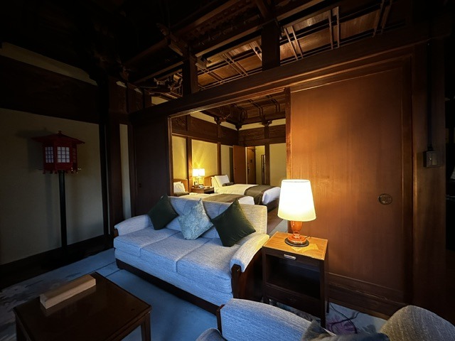 Warmly lit bedroom in the heritage wing of Fujiya Hotel Hakone featuring historic woodwork and classic furnishings