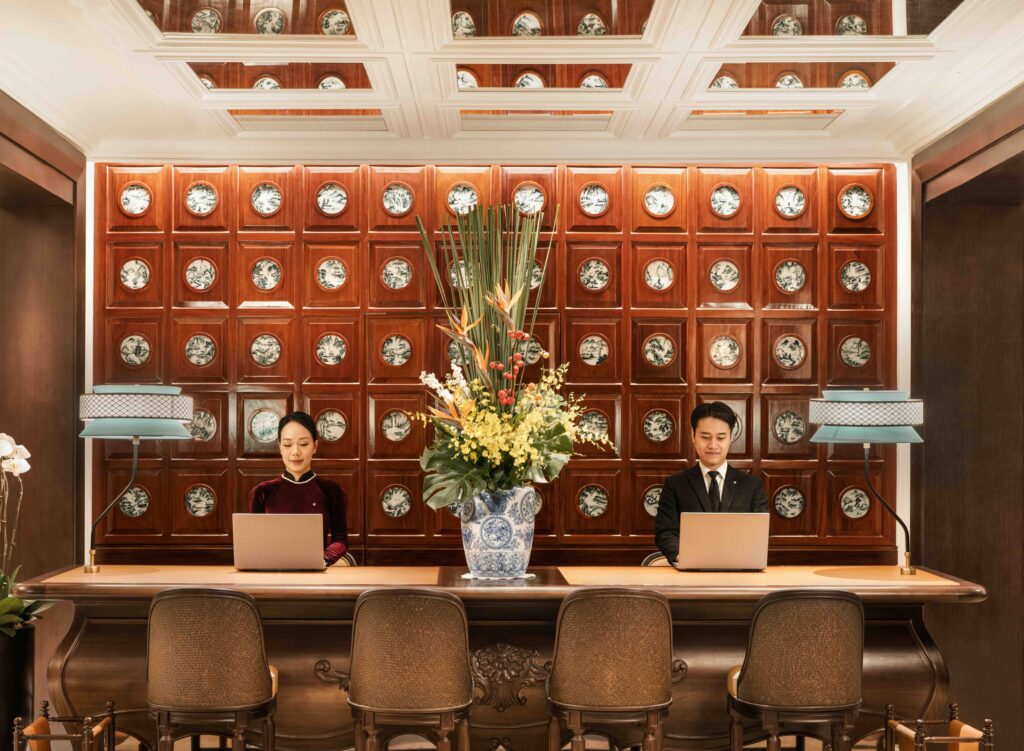 Reception lobby at Sofitel Legend Metropole Hanoi featuring elegant floral arrangements and refined French colonial design