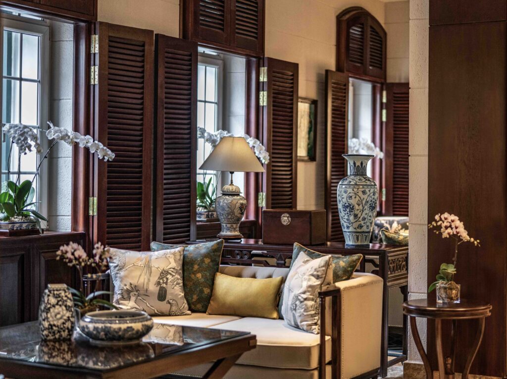 Elegant lounge interior at Sofitel Legend Metropole Hanoi featuring classic French colonial design, dark wood accents, and luxurious furnishings