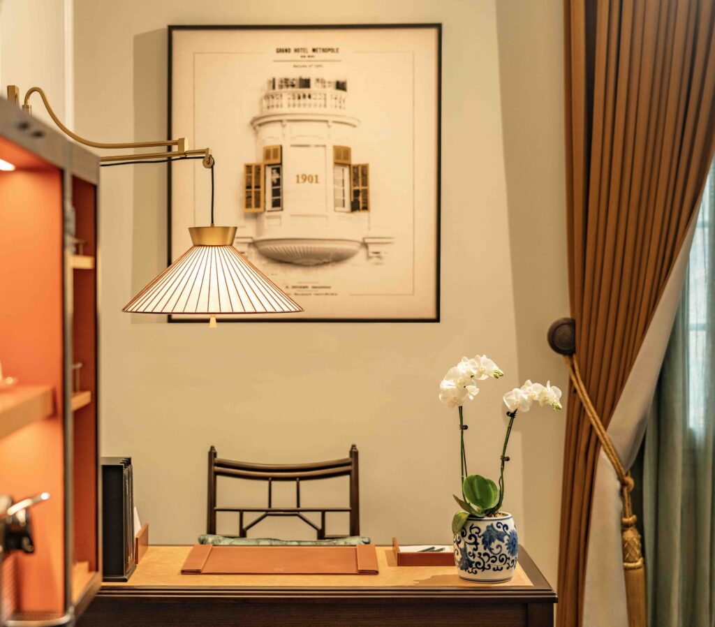 Elegant writing desk in a guest room at Sofitel Legend Metropole Hanoi featuring classic furnishings and French colonial design