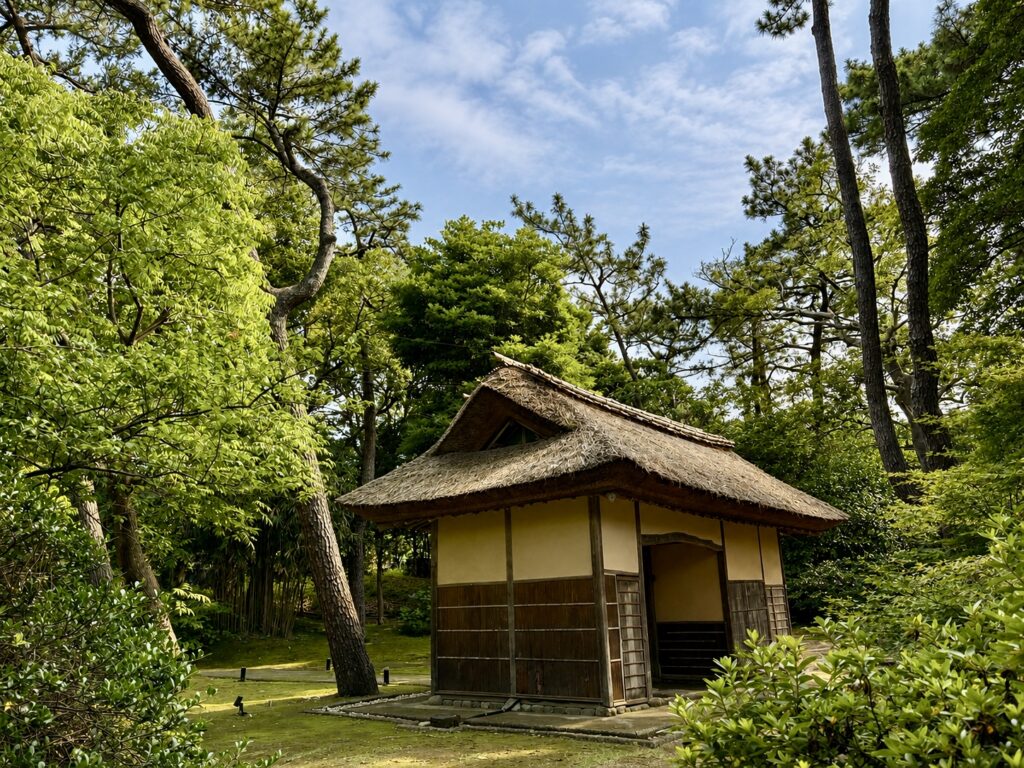 The historic Nagaya Gate at Numazu Club, Shizuoka, Japan, surrounded by mature pine trees and tranquil gardens. Photographed by Travelife Magazine.
