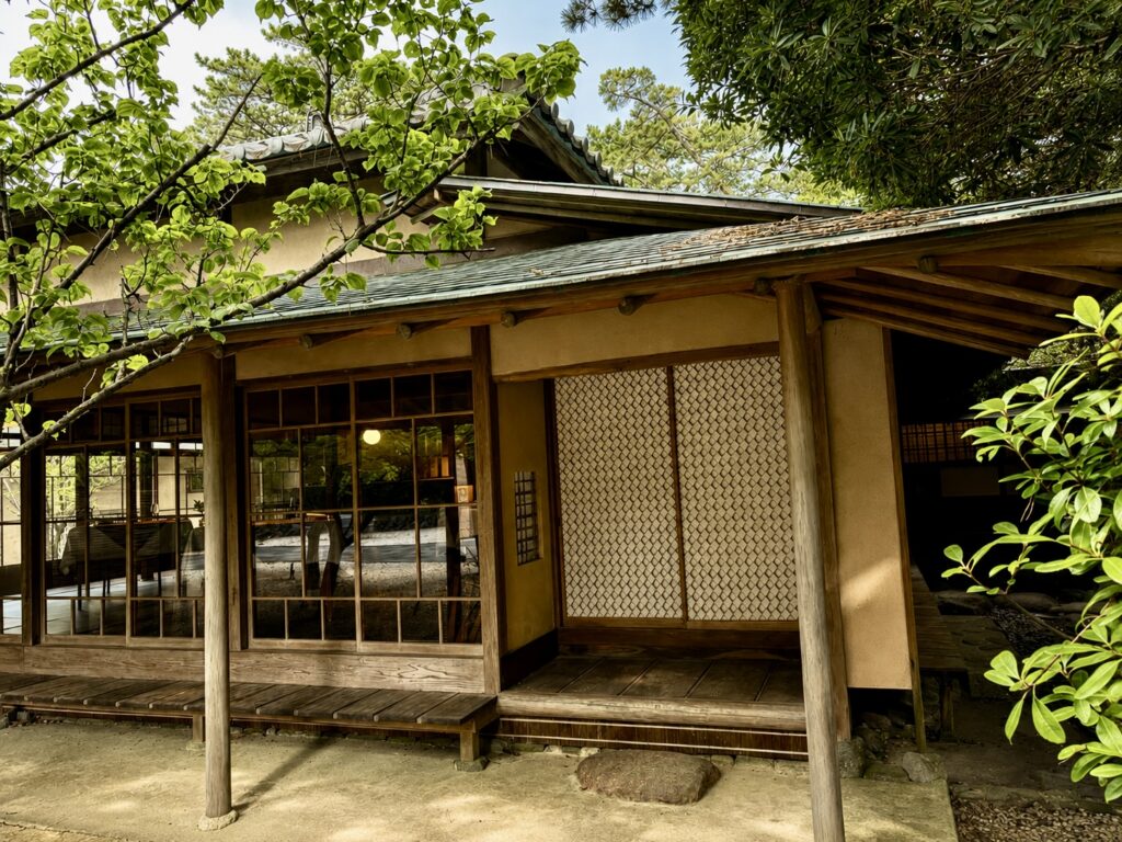 Traditional entrance to the 1913 heritage residence at Numazu Club, Shizuoka, Japan, featuring timber architecture, handcrafted shoji screens, and peaceful Japanese gardens. Photographed by Travelife Magazine.