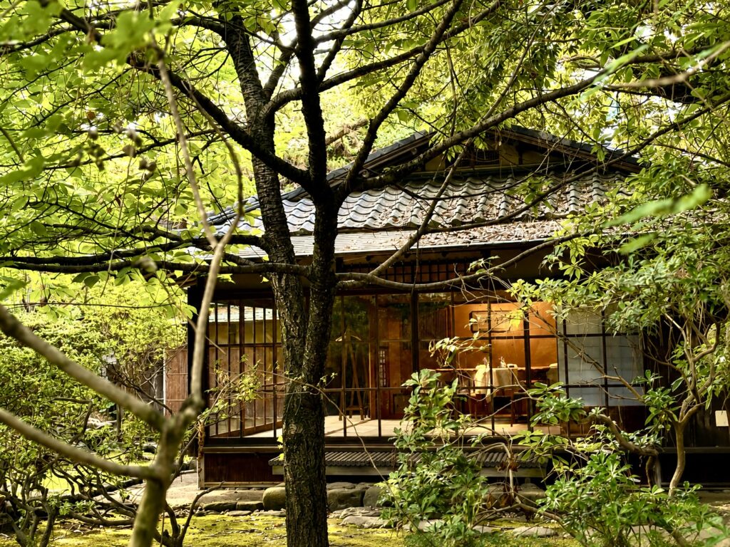 The 1913 heritage residence at Numazu Club, Shizuoka, Japan, nestled among mature trees and landscaped gardens, showcasing the estate’s timeless Japanese architecture. Photographed by Travelife Magazine.