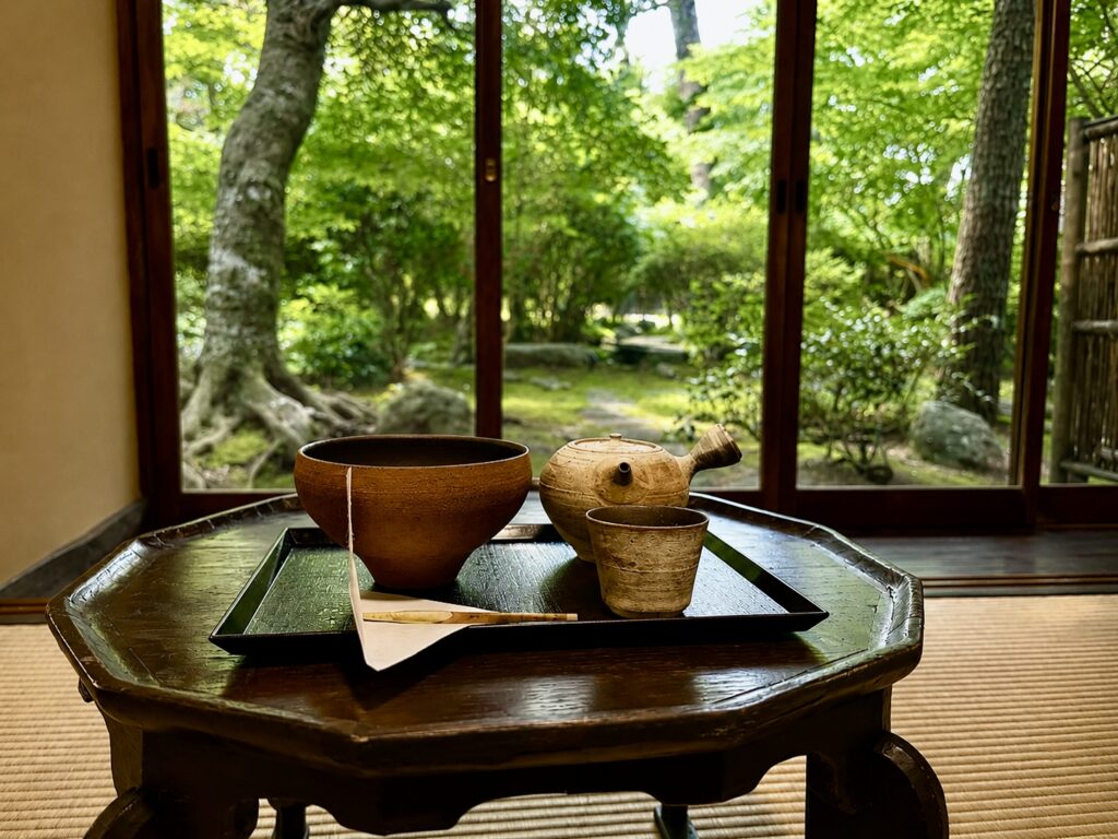 Traditional Japanese tea service overlooking the gardens at Numazu Club, Shizuoka, Japan, where guests experience the property’s signature meditation and tea ritual. Photographed by Travelife Magazine.