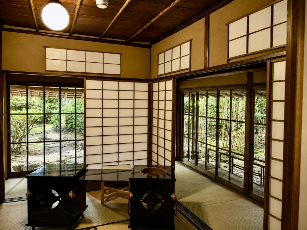 Traditional Japanese reception room in the 1913 heritage residence and Tangible Cultural Property at Numazu Club, Shizuoka, Japan, featuring tatami floors, shoji screens, timber architecture, and views of the estate gardens. Photographed by Travelife Magazine.