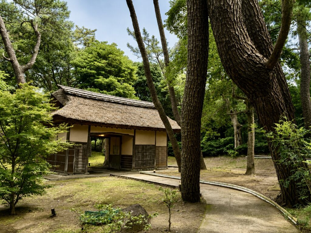 The historic Nagaya Gate at Numazu Club, Shizuoka, Japan, nestled among mature pine trees and landscaped gardens. Photographed by Travelife Magazine.