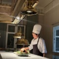 Chef preparing a dish in the open kitchen at Baan Phraya, the Thai fine-dining restaurant at Mandarin Oriental, Bangkok.