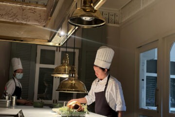 Chef preparing a dish in the open kitchen at Baan Phraya, the Thai fine-dining restaurant at Mandarin Oriental, Bangkok.