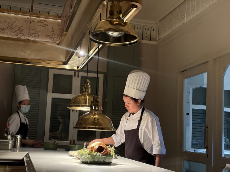 Chef preparing a dish in the open kitchen at Baan Phraya, the Thai fine-dining restaurant at Mandarin Oriental, Bangkok.