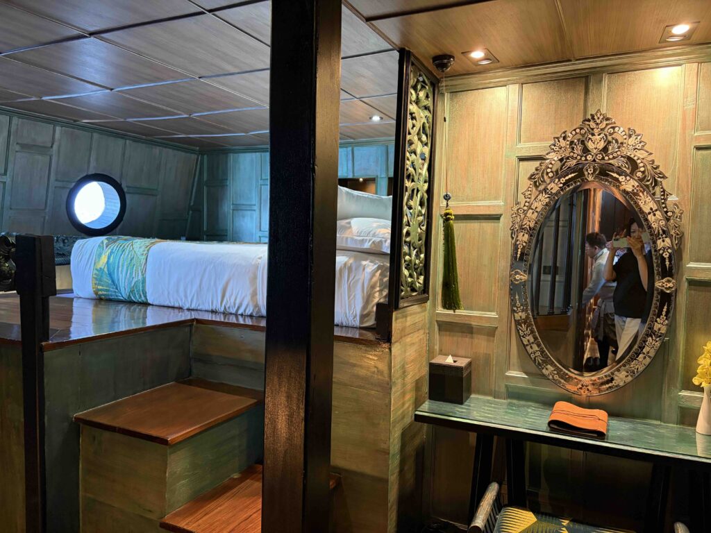 Master stateroom aboard Loy Dream, Anantara’s restored Thai rice barge on the Chao Phraya River