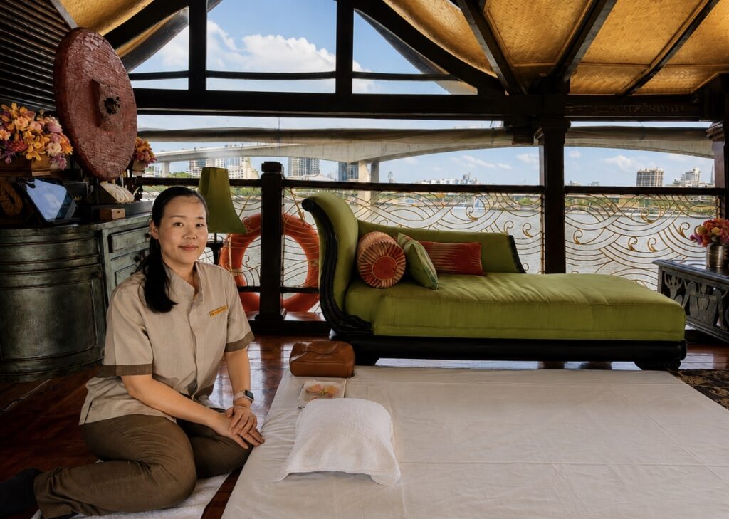 Gua sha facial on the upper deck of Loy Dream during an Anantara Bangkok river cruise