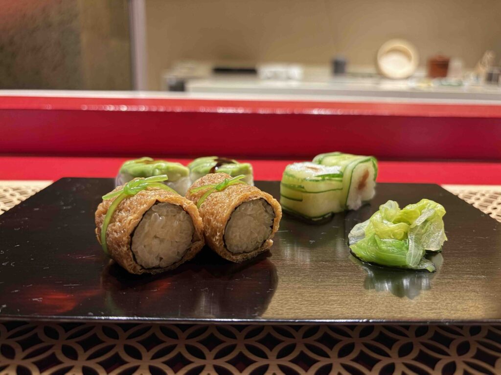 Japanese vegetable cuisine elegantly presented on a dark rectangular plate at Pasona Natureverse Retreat on Awaji Island, Japan.