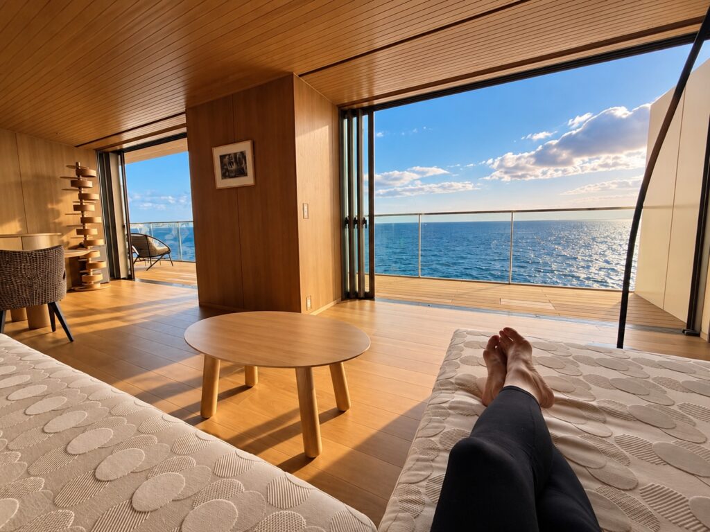 Oceanfront lounge at THE PASONA natureverse retreat on Awaji Island, Japan, with floor-to-ceiling windows overlooking the sea.